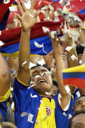 A fan of Colombia cheers as he releases confetti during the CONCACAF Gold Cup soccer quarter final match of Colombia vs Brazil at the Orange Bowl in Miami, Florida