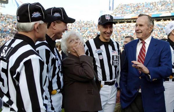 Former US President George H.W. Bush (R) and former first lady Barbara Bush (2ndL) talk with game officials prior to the start of Super Bowl XXXIX at Alltel Stadium in Jacksonville, Florida.