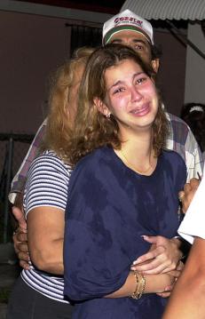 The cousin of Elian Gonzalez cries in front of tthe Miami home after Federal agents stormed Gonzalez's home early 22 April 2000 and took the boy in their custody. 